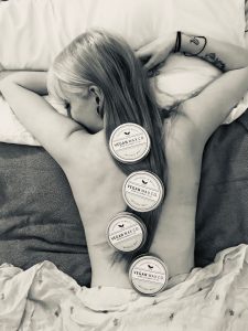 Vegan Wax Co pots on lady's back - black & white